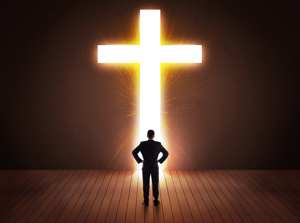 Man looking at bright cross sign concept Man looking at bright cross sign concept